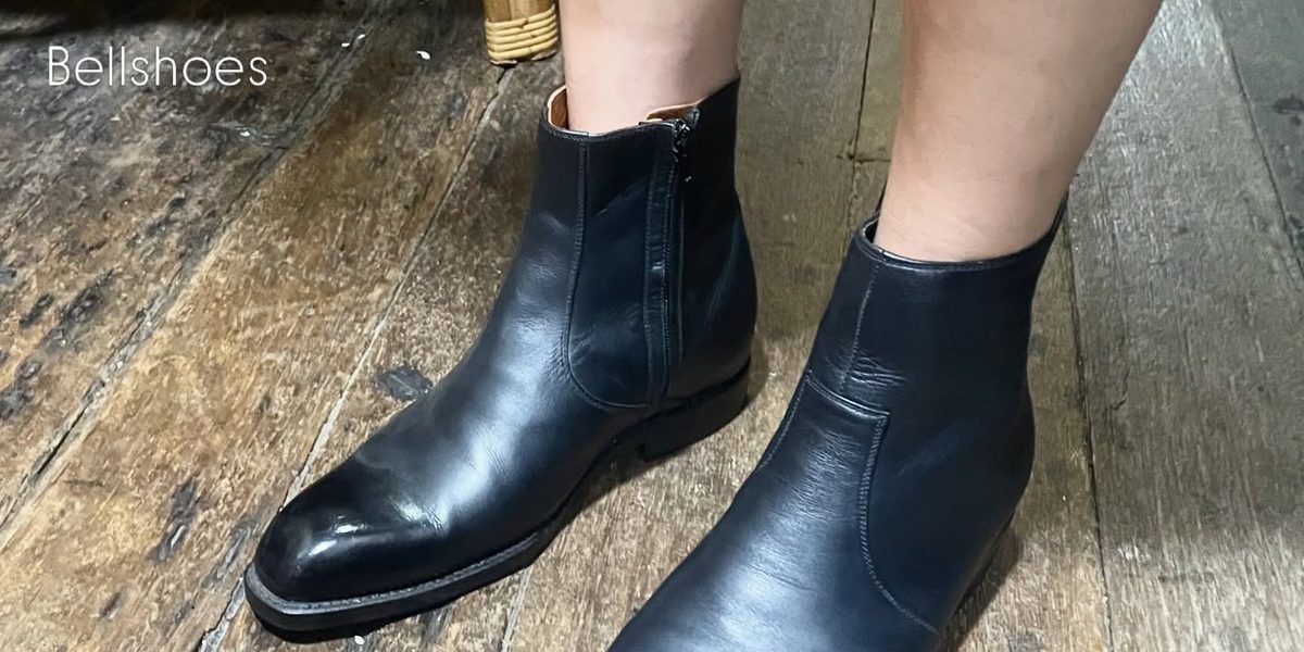 Black side-zip ankle boots, worn by a client