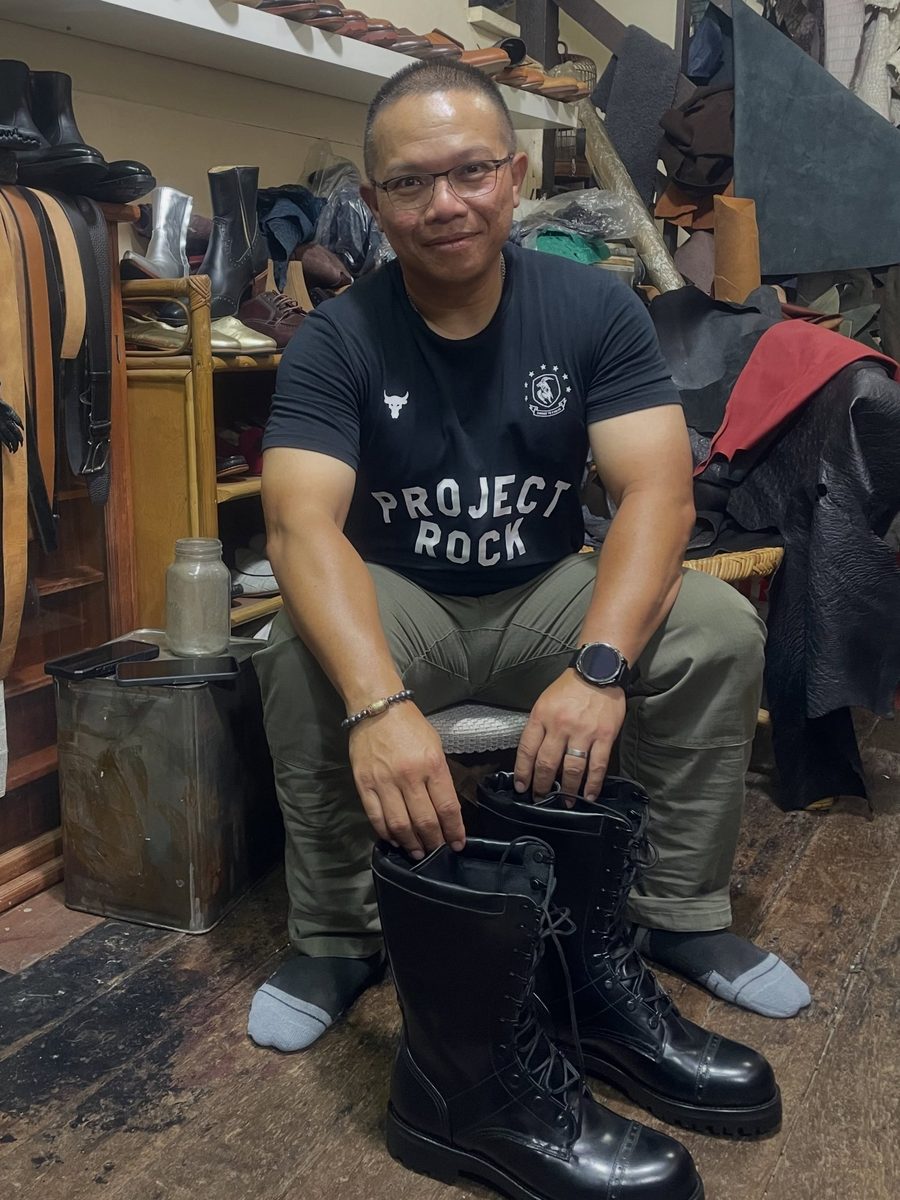 A client in the atelier with his lace-up boots